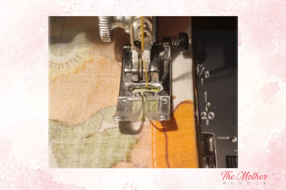 sewing the bottom edge of the upcycled skirt