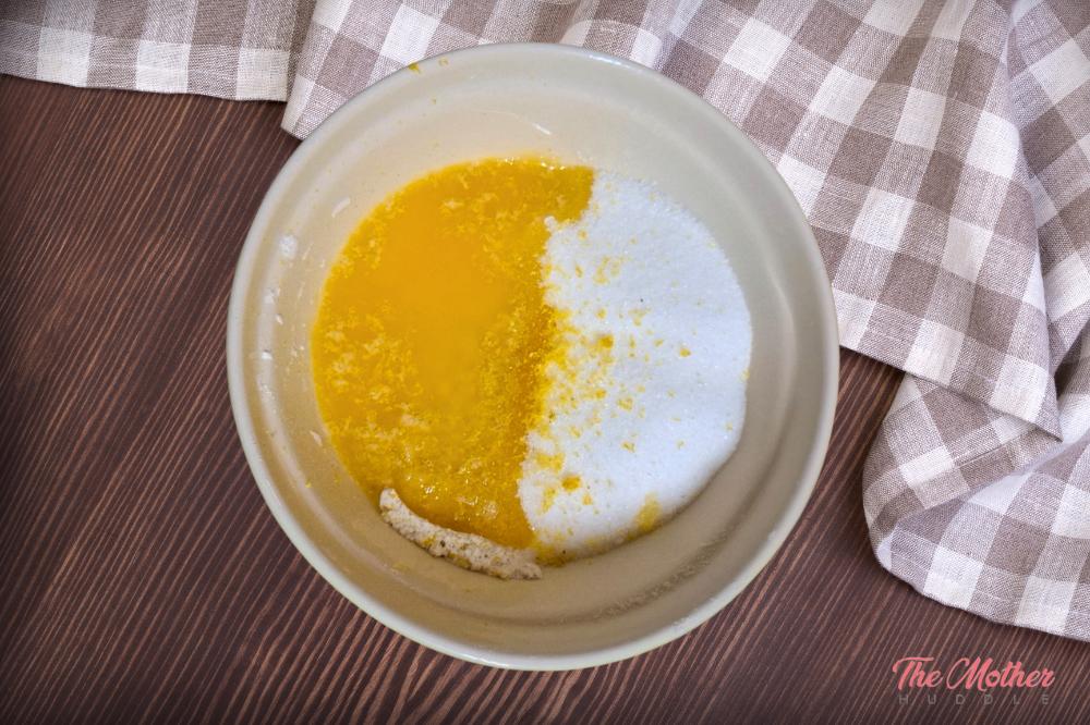 add flour and sugar and grate the rind off the whole lemon into the bowl