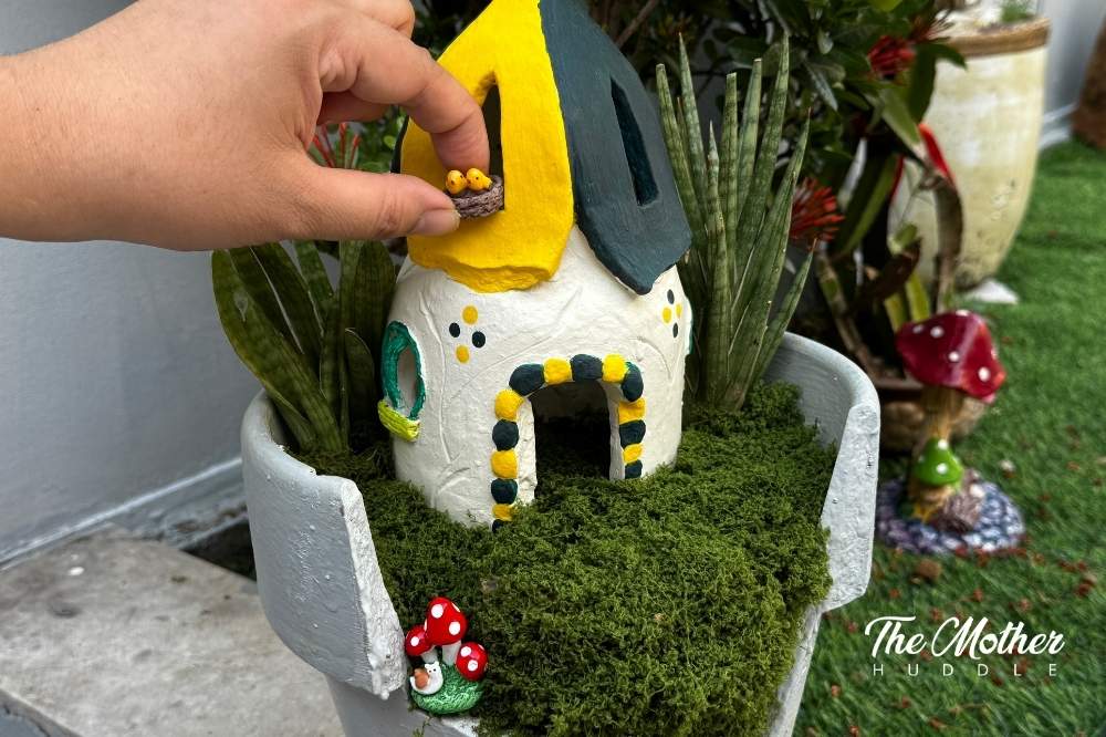 Adding the miniatures in the fairy garden