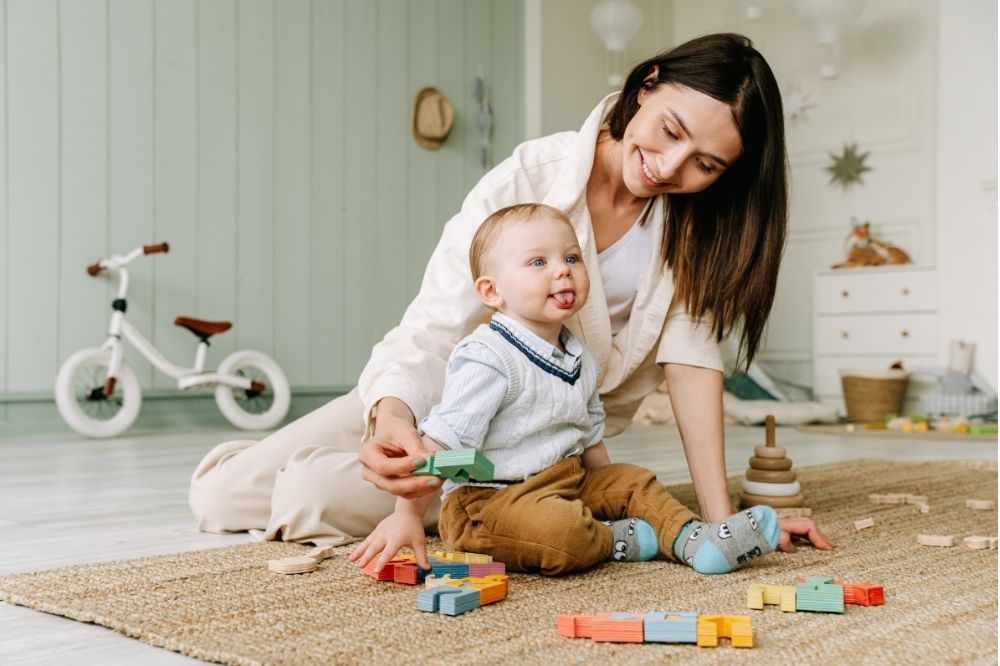 Mom playing with baby on the floor