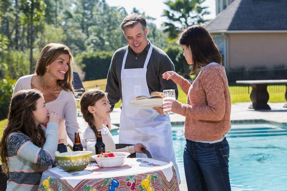 happy family eating in the backyard