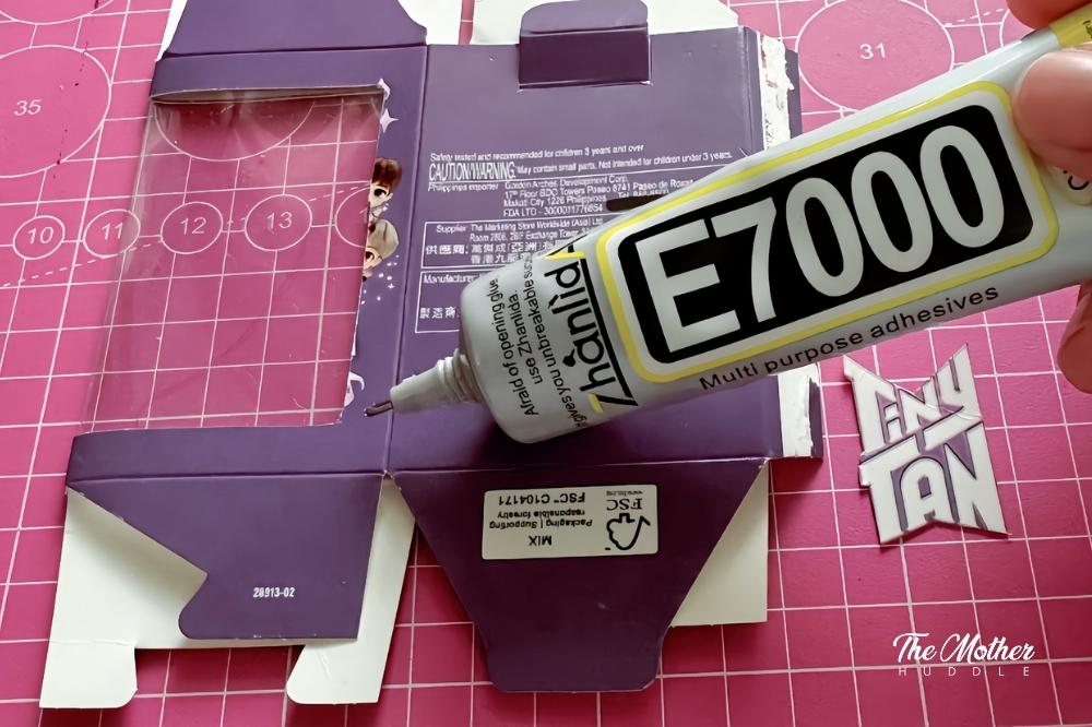 glue the Tiny Tan logo to the other side of the window at the lower-right corner.