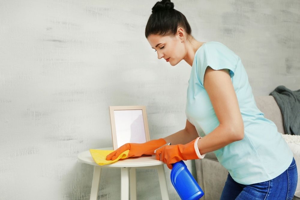 a lady cleaning a table